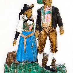 Wooden cut-out of a Ladin couple in the village square — San Cassiano, Italy.