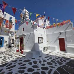The churches have red roofs, unlike the blue roofs of the Santorini churches