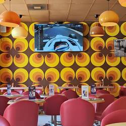 F1 racing on tv while I eat lunch in a retro cafe