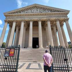 Roger dwarfed by the Roman columns that surround Èglise de la Madeleine