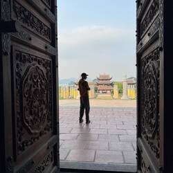 Looking back at the entrance gate through the first temple doors.