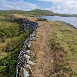 On top of Llyn Fyrddon Fawr dam which appears to be bulging on the left / east side