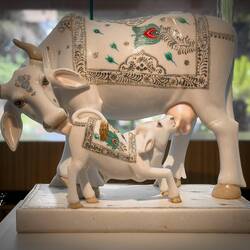 Kamdhenu Cow w/Calf; symbol of nurturing animals in rural communities & practice of organic farming.