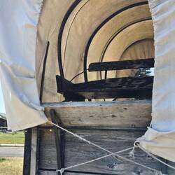 Covered wagon front seat on display.