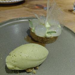Matcha cream tart with spun sugar decoration like butterfly wings