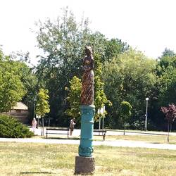 The Szépasszony-szobor (Statue of the Beautiful Woman) - holding a cluster of grapes and a wine jug.