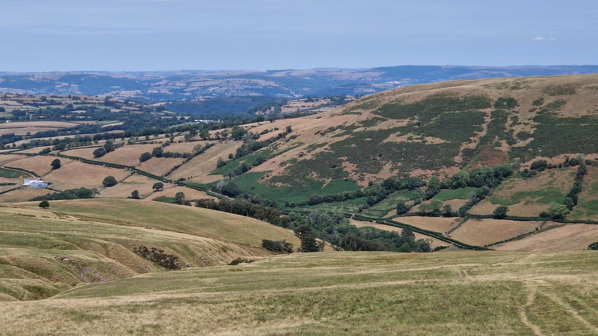 View north over Llanddeusant and beyond from Cefn Nant Lygos part way up the moorland