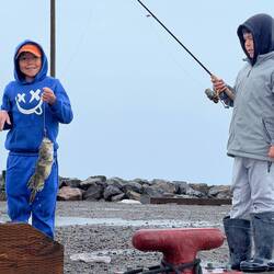 The "ugly fish" (Sculpin) is proudly demonstrated.