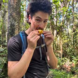 Trying some kind of native fruit we can't remember the name of
