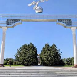 Glimpse of the Independence Memorial through the arch with the storks