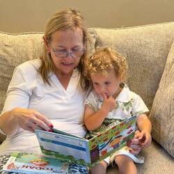 Karen and Logan in his elephant outfit reading Tikkun Olam