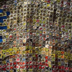 "Breaking News" detail (El Anatsui; 2015); aluminum liquor bottle caps stitched with copper thread.