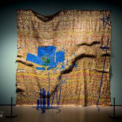 "Breaking News" (El Anatsui; 2015) ... aluminum liquor bottle caps stitched with copper thread.