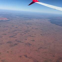 Uluru on the left, Kata Tjuṯa on the right, town of Yulara in the middle