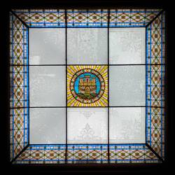 Zooming in from the lobby, the yellow and pink in the ceiling glass become apparent — Permanenten.