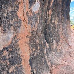 Rock is actually grey in colour, the iron in the rock makes it red