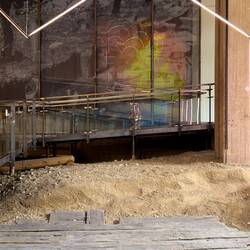 Behind the structure is a panel depicting one of the many fires that destroyed parts of Bergen.