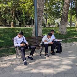 Workers have a break in the park - all in modern Uzbek uniform: black & white