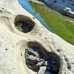 Look at these smaller rocks inside these weathered holes.