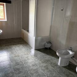 Bathroom with a BATHTUB! If you run the water full hot before you get in, there's enough