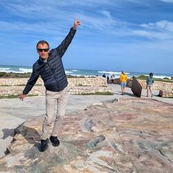 Peter summiting Mt Kilimanjaro on the 3d relief map of Africa at Cape Agulhas