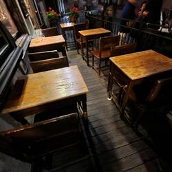 The terrace tables look like student desks