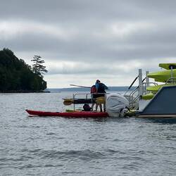 Offloading kayaks and kayakers.