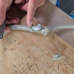 Cleaning up the damage on the mainsail halyard.