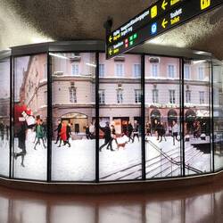 Layered glass showing people walking in the snow