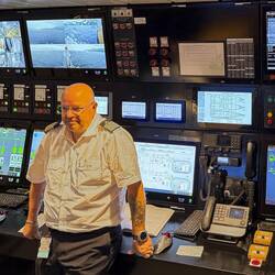 Chief engineer explaining what all the monitors are in the engine control room.
