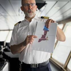 Captain Bruland using a visual aid as he explains about the propulsion system.