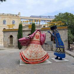 Baku Old Town - giant statues painted in traditional rug motifs dance outside carpet workshops