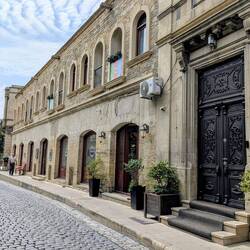 Baku Old Town - one of the many small ancient roads with the Flame Towers as futuristic backdrop
