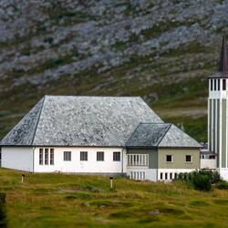 Mehamn's concrete church was built in 1965 in a long church architectural style.