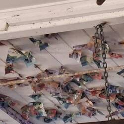 Money nailed to roof is donations for local community