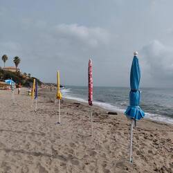 The umbrella sentinels guarding a families 'patch' on the beach