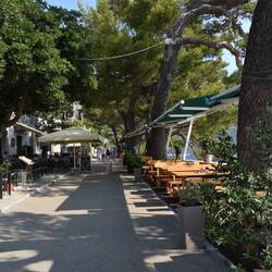 Walkway along the outside lined with restaurants