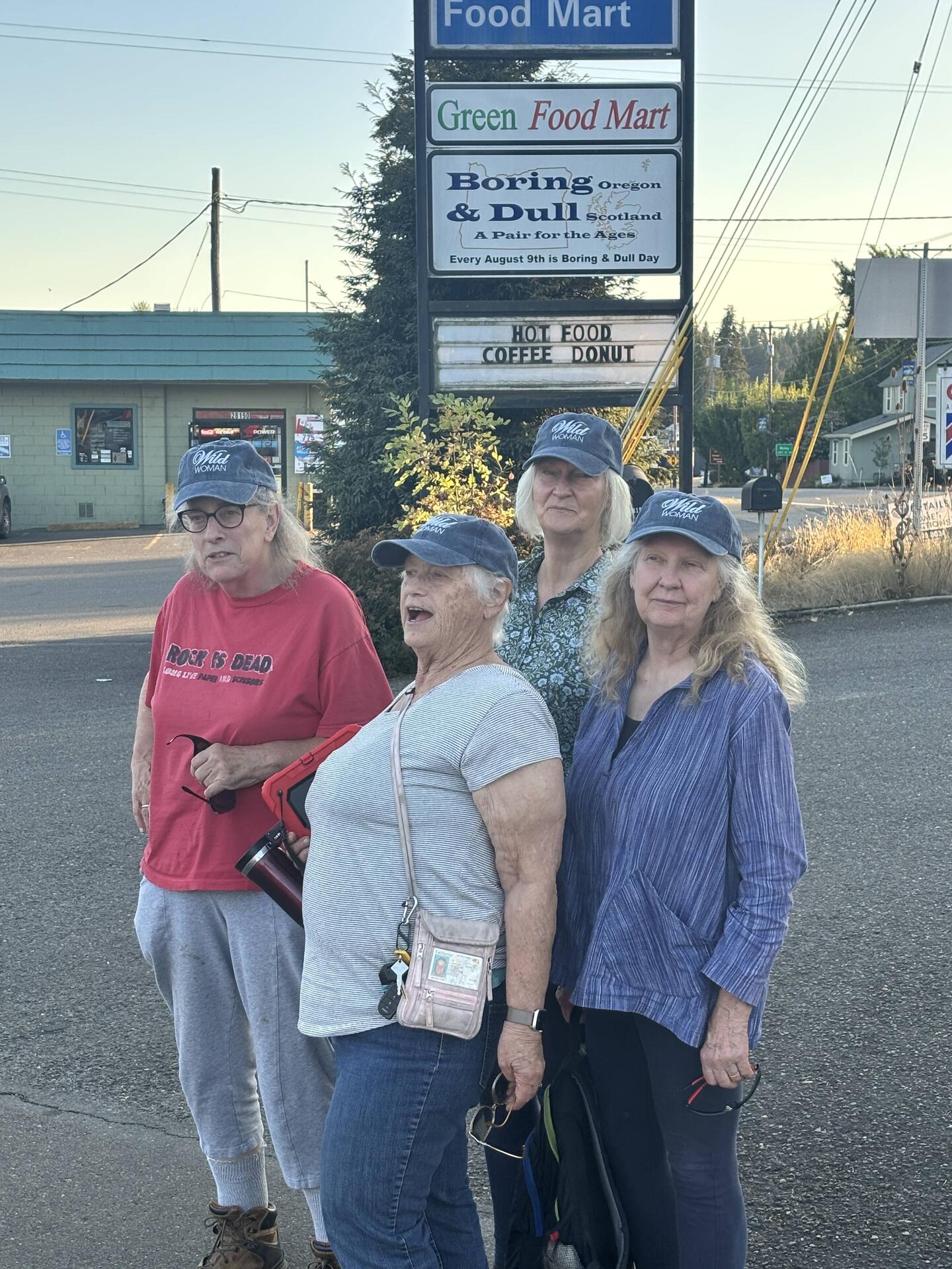 The Wild Women posed for a photo in front of the sign