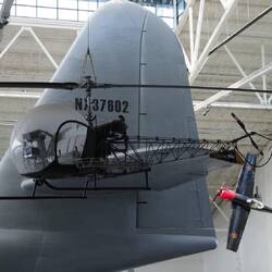 A Bell medivac helicopter from Korean War, with the tail of the Spruce Goose