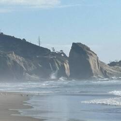 Waves crashing on the rocks in the distance