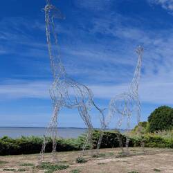 The giraffes is a humorous nod to the cranes of the Verdon at Bordeaux port, opposite