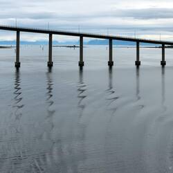 Squiggly reflections of the bridge piers.