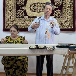 Jumayev demonstrating how he prepares the pattern using the stork scissors made by local blacksmith