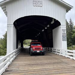 Les driving the Big Red through Pengra Covered Bridge