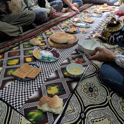 Bread being broken and served with tea - one is expected to dip the bread into the tea