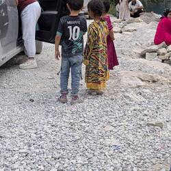 Children trying to sell homemade beads and also begging