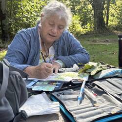Signing her art