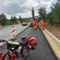 These road workers waved me onto their fresh pavement to escape the traffic.