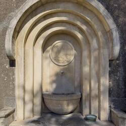 Fountain with stone carving of the coat of arms of San Marino.