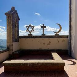 Star of David, Christian Cross, and Islamic Crescent on the belfry of the Nuova Chapel.